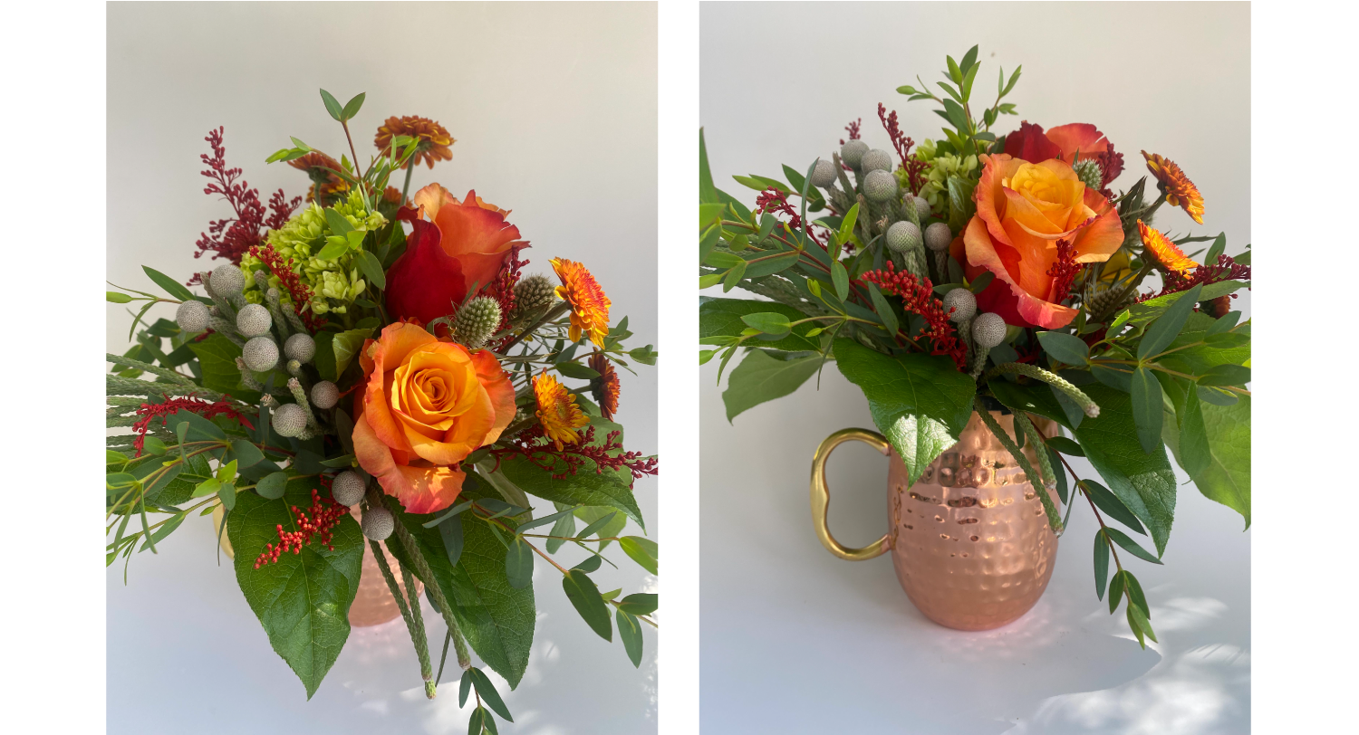 A copper mug filled with fresh flowers on a white background.