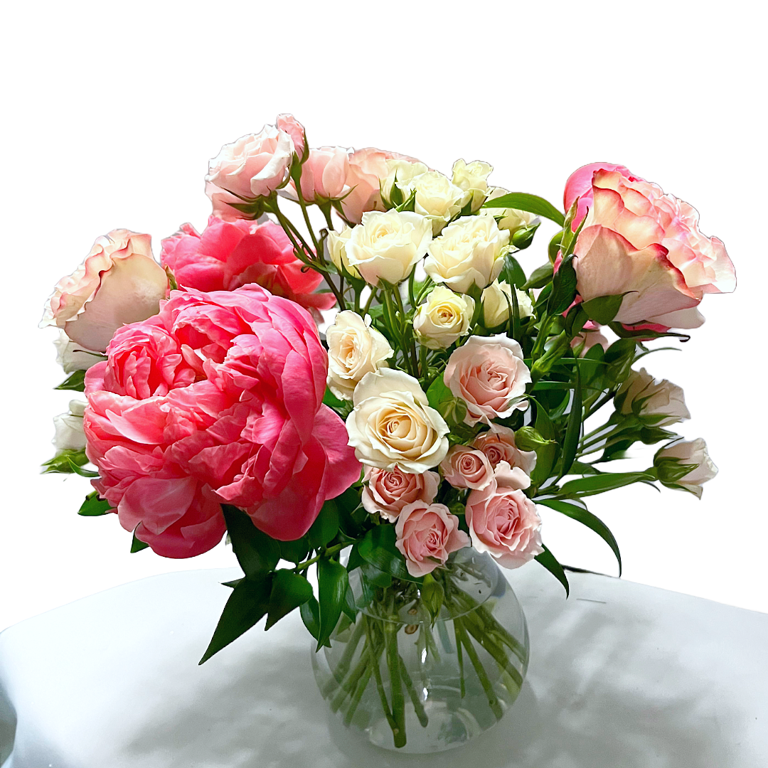 A vase filled with pink and white flowers for debutantes.