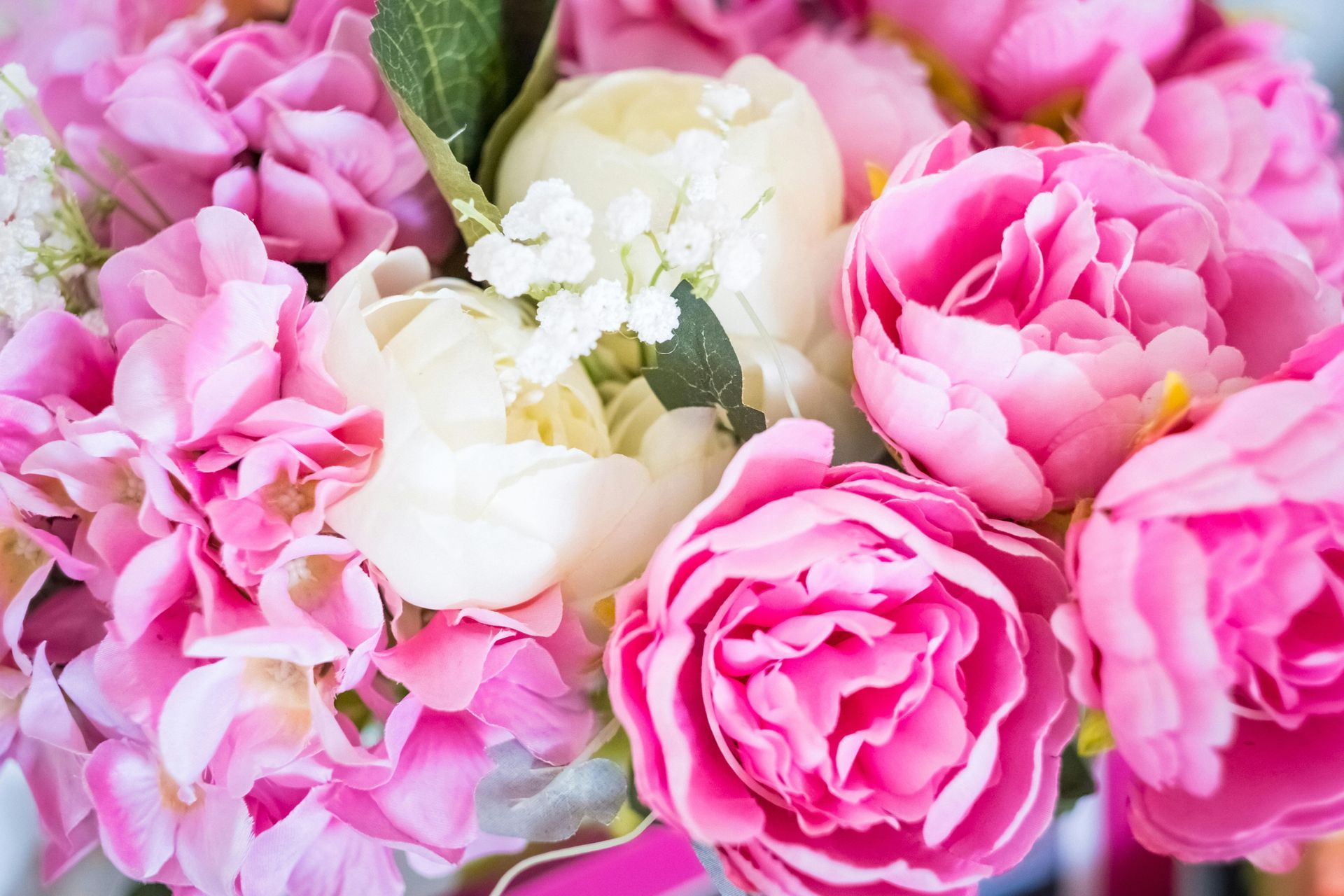 A close up of a bouquet of pink and white peonies.