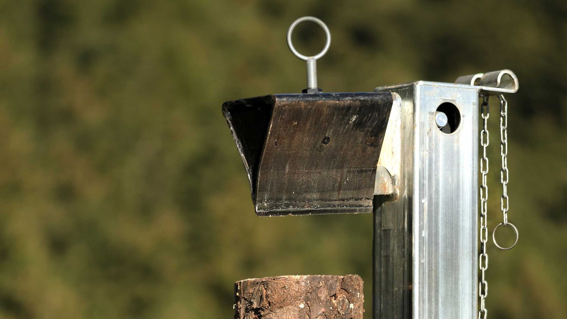 A close up of a metal object with a chain attached to it.