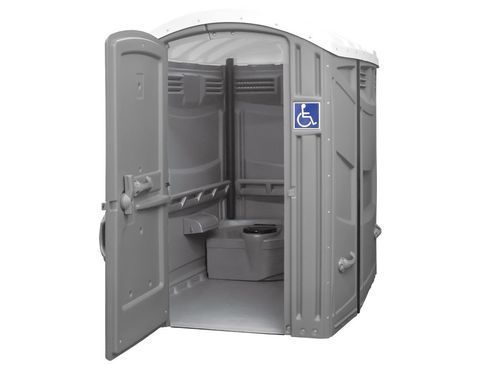 A portable toilet with a handicap sign on the door.