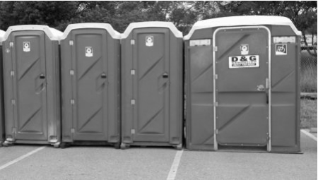 A row of portable toilets with one that says d & g on it