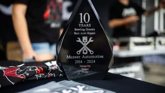 Black award for Massey Automotive's 10th anniversary. Features text and a wrench logo on a table. | Musser Automotive