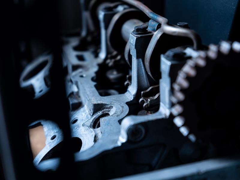 Close-up of a cylinder head at an angle, highlighting precision engineering at Musser Automotive.