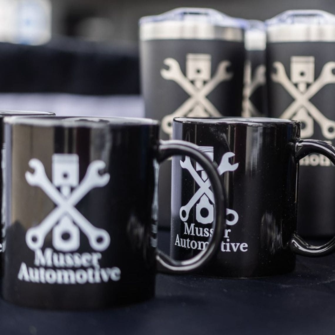 A group of musser automotive mugs are sitting on a table