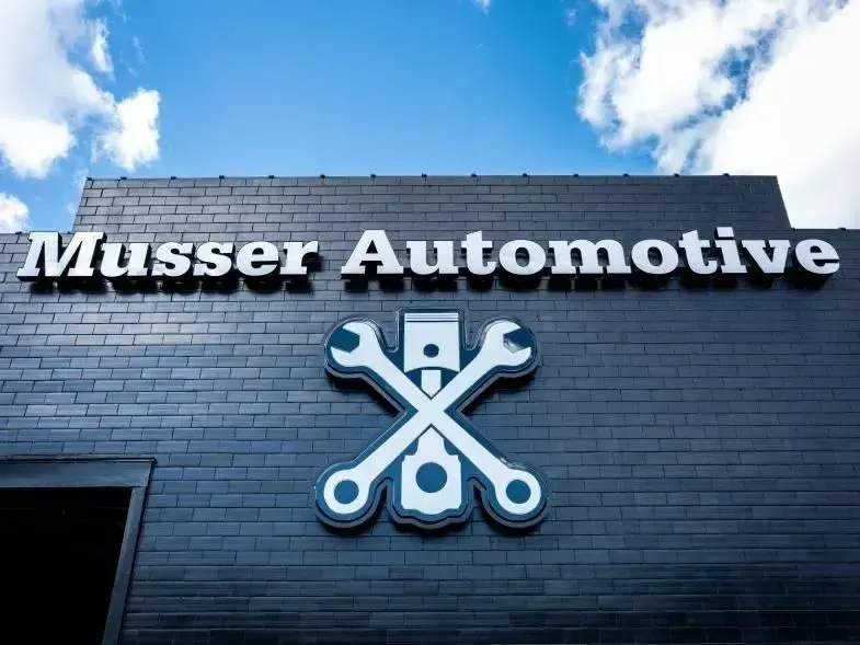 Front of Musser Automotive building in Bowling Green, KY, featuring company logo and modern signage.