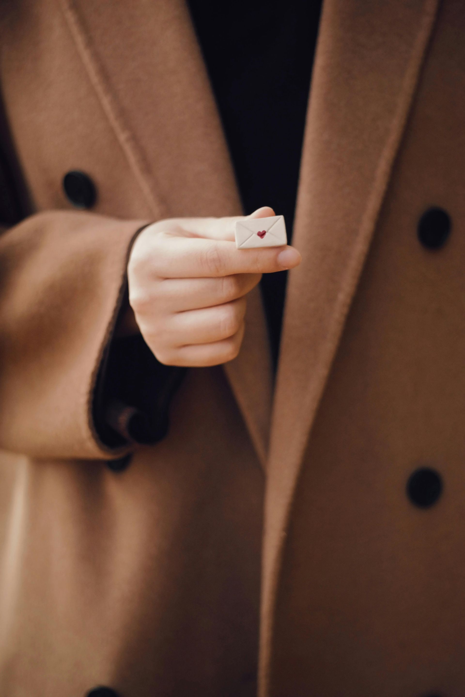 Man holding a tiny letter with a heart symbolizing love and care while planning his estate in San Diego