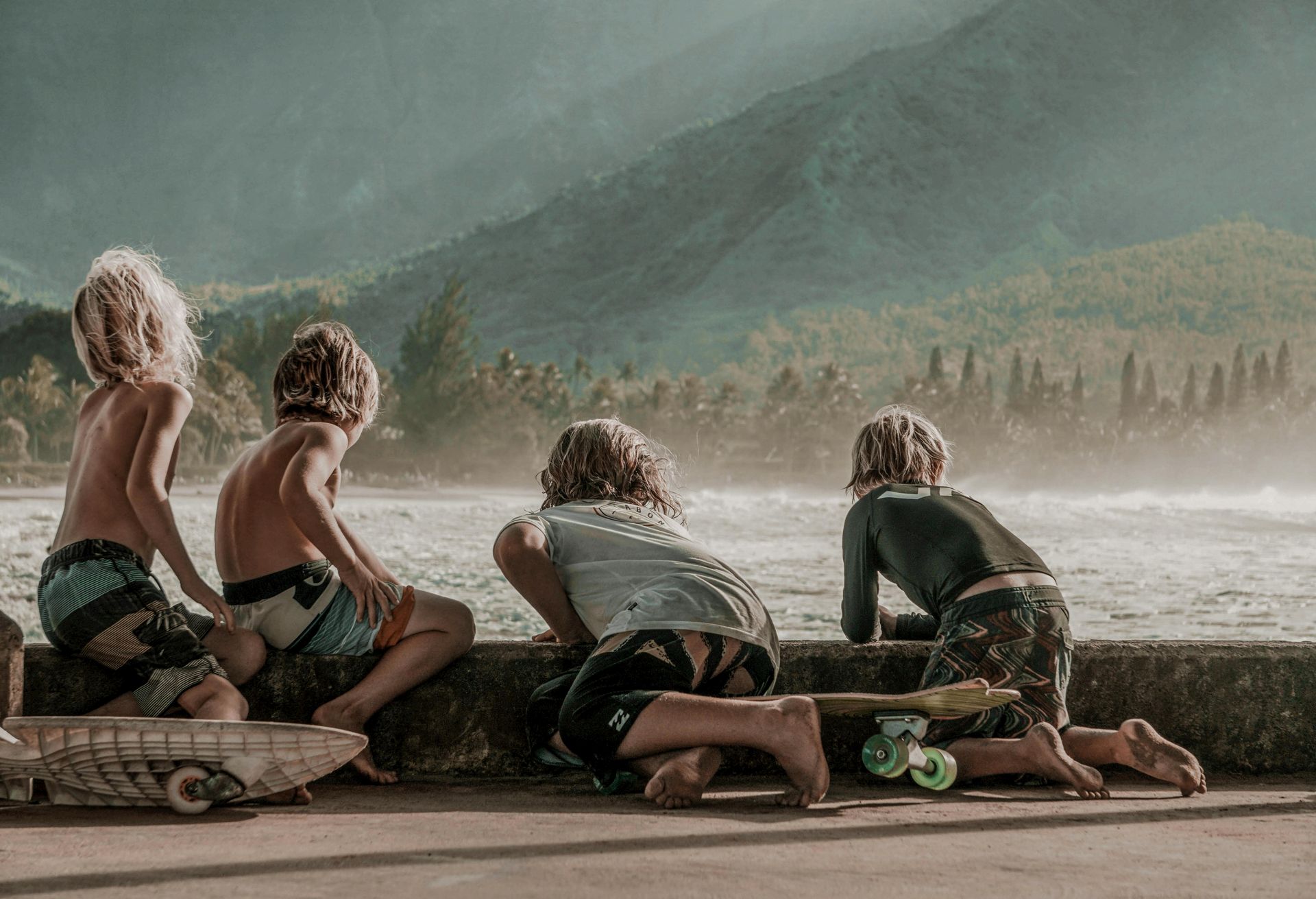 Happy siblings playing on the beach during a family trip, safe and secure thanks to a comprehensive.
