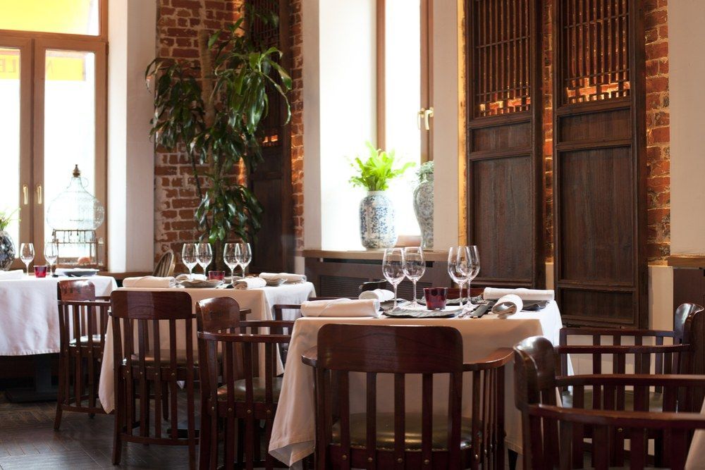 A Restaurant Filled With Tables and Chairs and Glasses of Wine ā Kowin Restaurant in Wingham, NSW