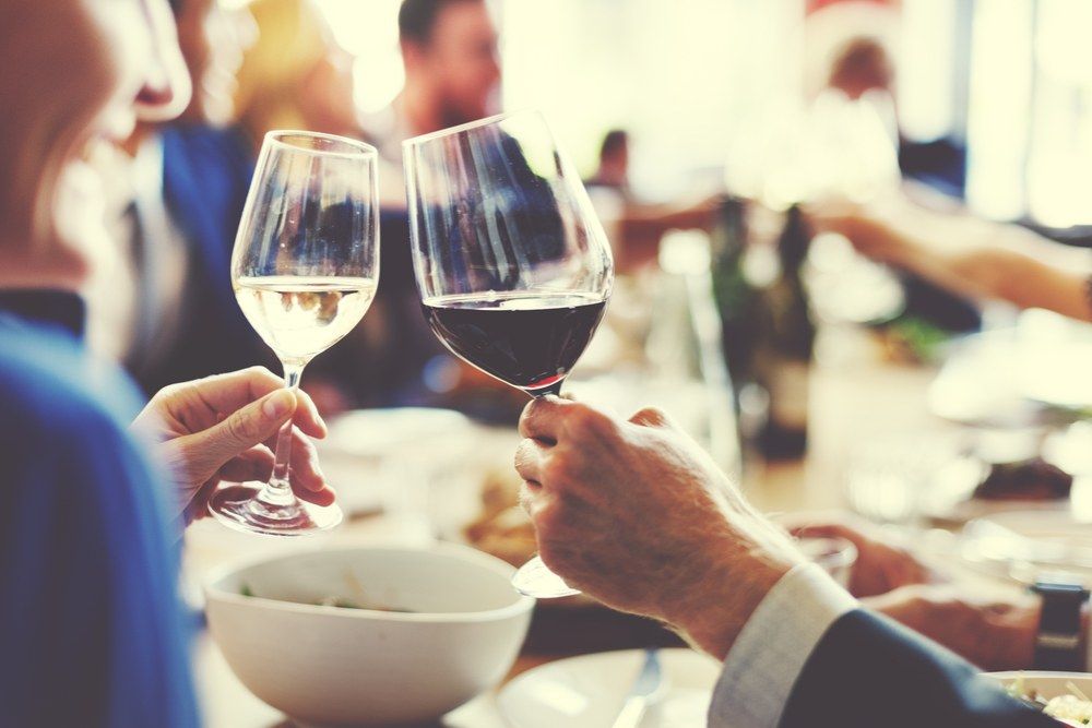 A Group of People Are Toasting With Wine Glasses at a Table — Kowin Restaurant in Forster, NSW