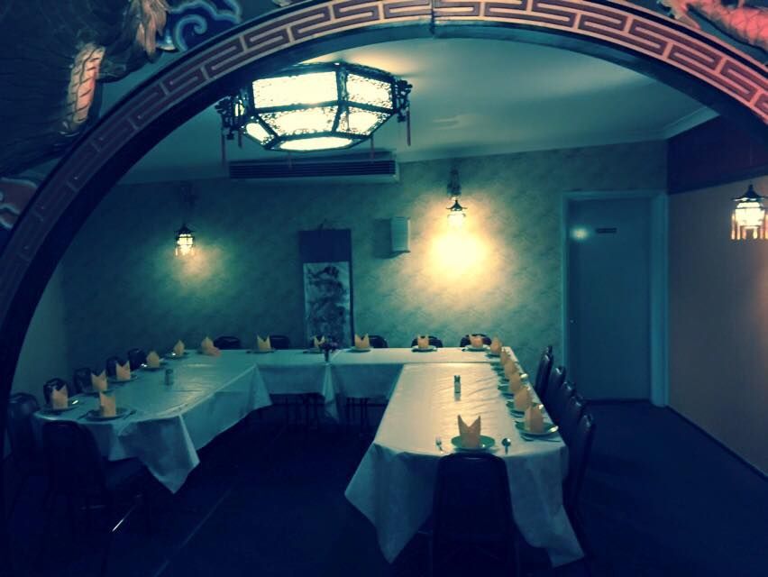 A Room With Tables and Chairs and a Chandelier — Kowin Restaurant in Old Bar, NSW