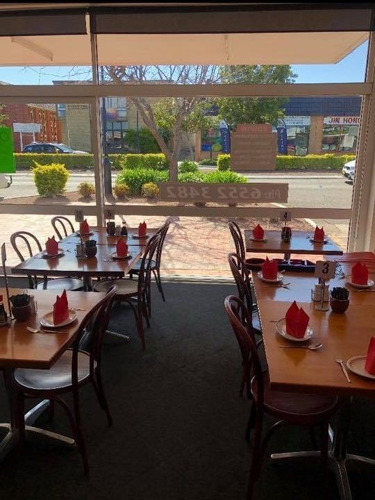A Restaurant With Tables and Chairs and a Large Window — Kowin Restaurant in Taree, NSW