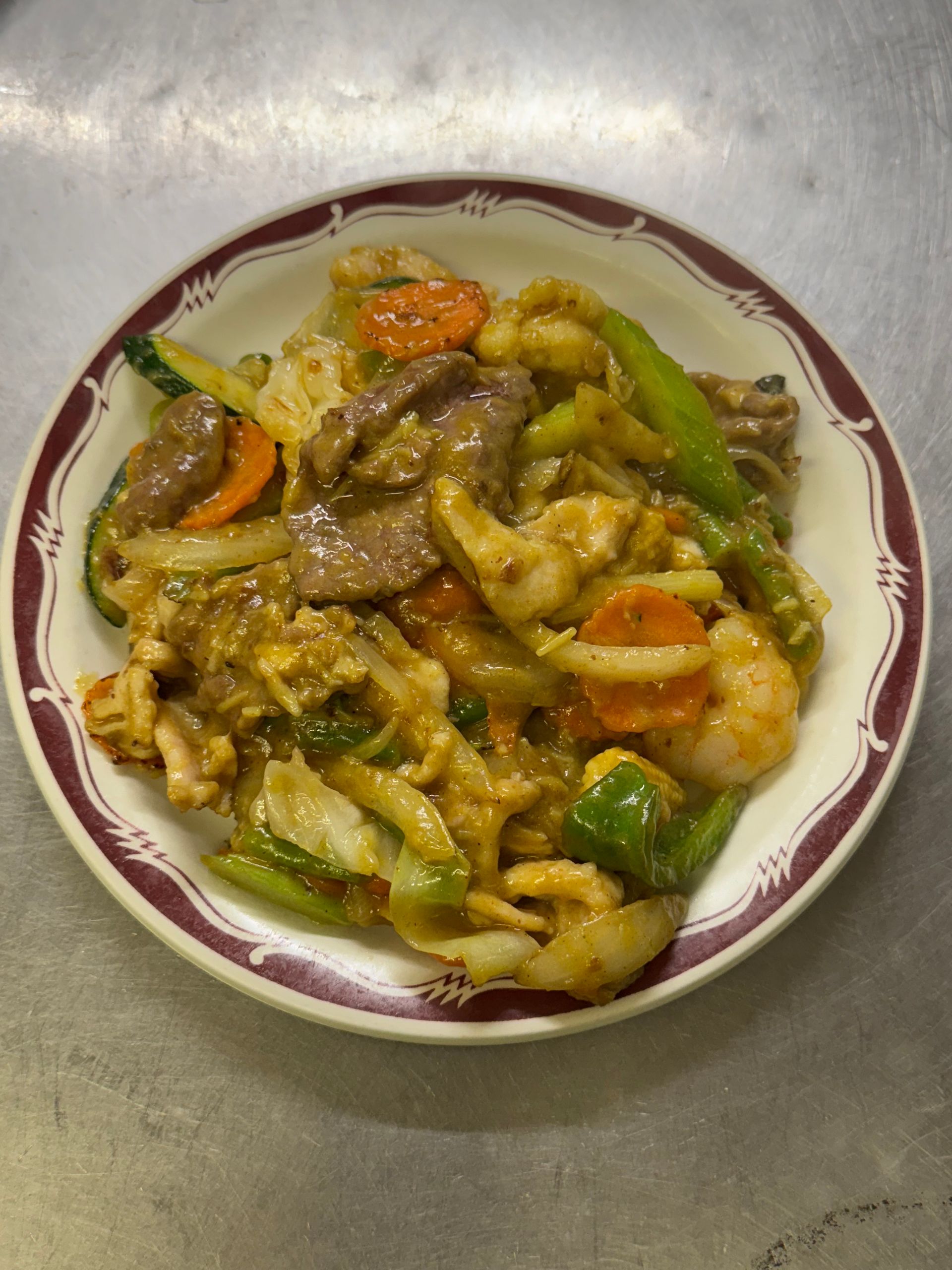 Stir-fry with vegetables and meat in a white and red patterned bowl. — Kowin Restaurant in Old Bar, NSW