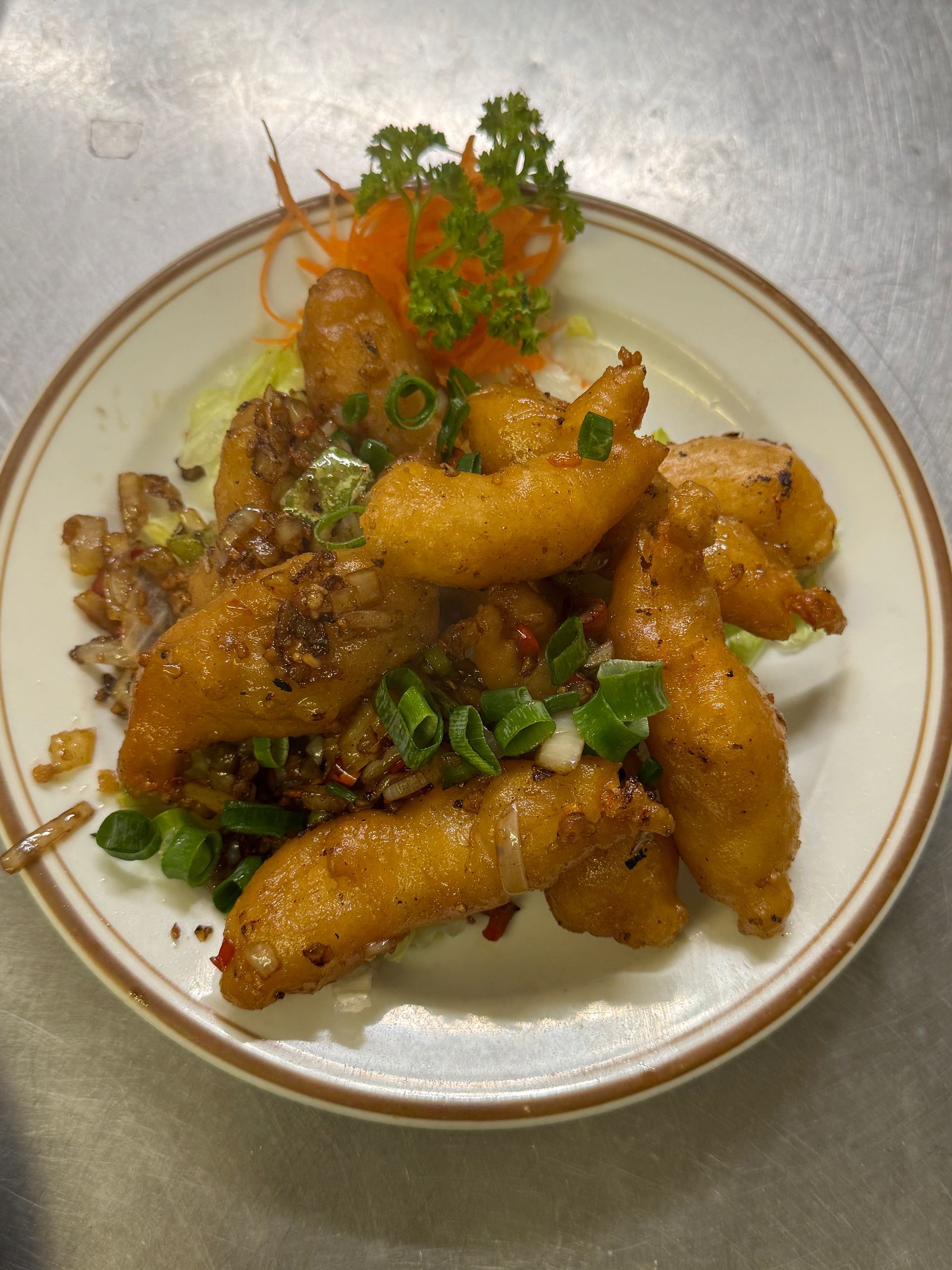 Fried shrimp dish on a plate, garnished with green onions, carrots, and parsley. — Kowin Restaurant in Taree, NSW