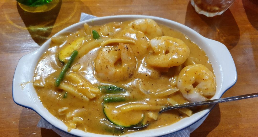 A Bowl of Shrimp and Vegetables With a Spoon in It on a Table — Kowin Restaurant in Forster, NSW