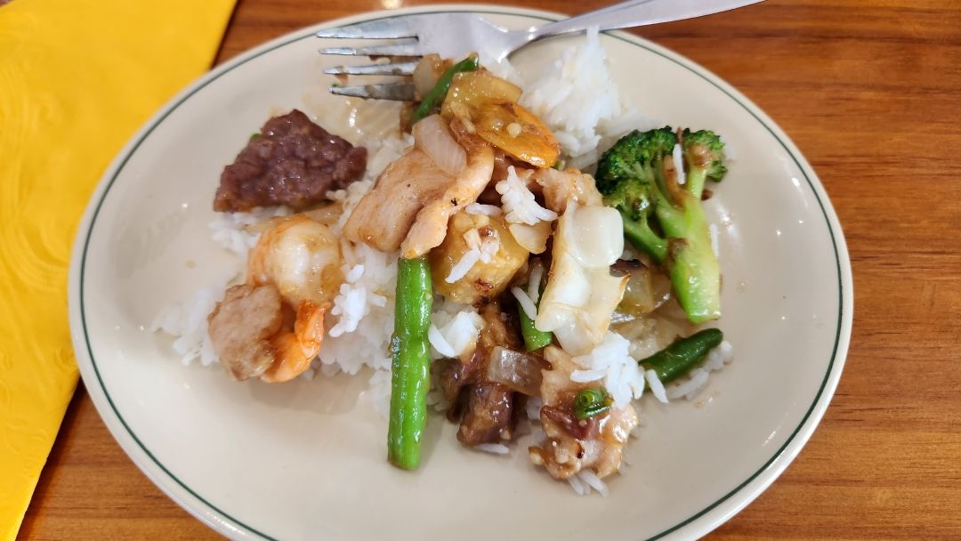 A Plate of Food With Rice and Broccoli on a Table — Kowin Restaurant in Harrington, NSW