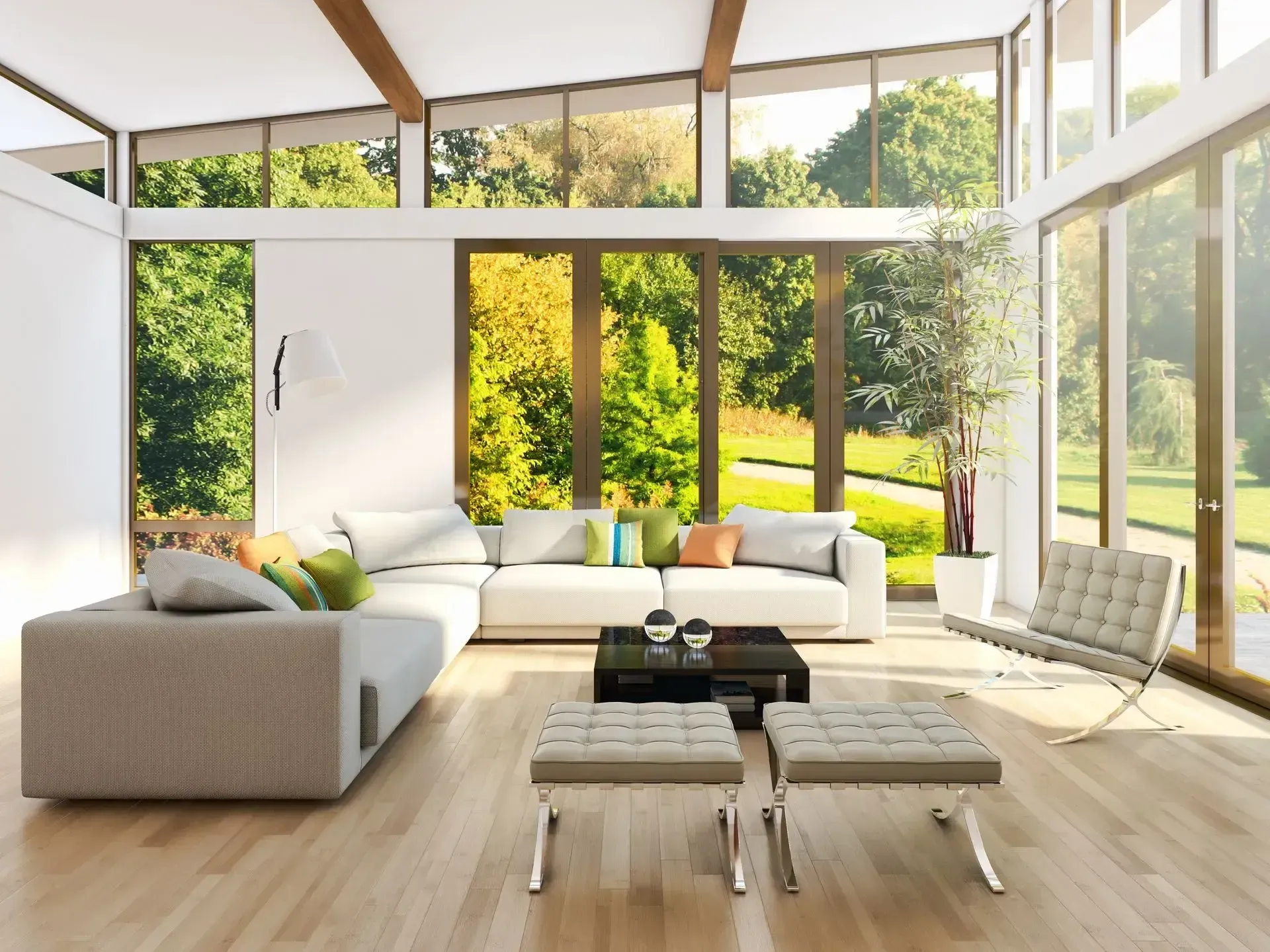 Bright living room with large windows, modern furniture, and a view of trees.