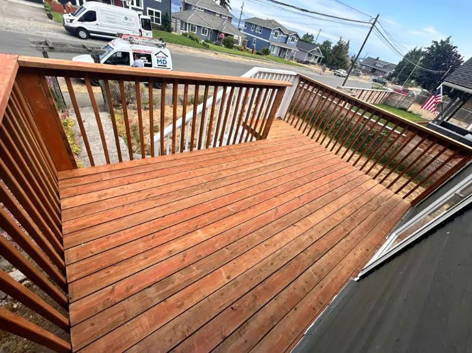 A wooden deck with a railing and stairs leading up to it
