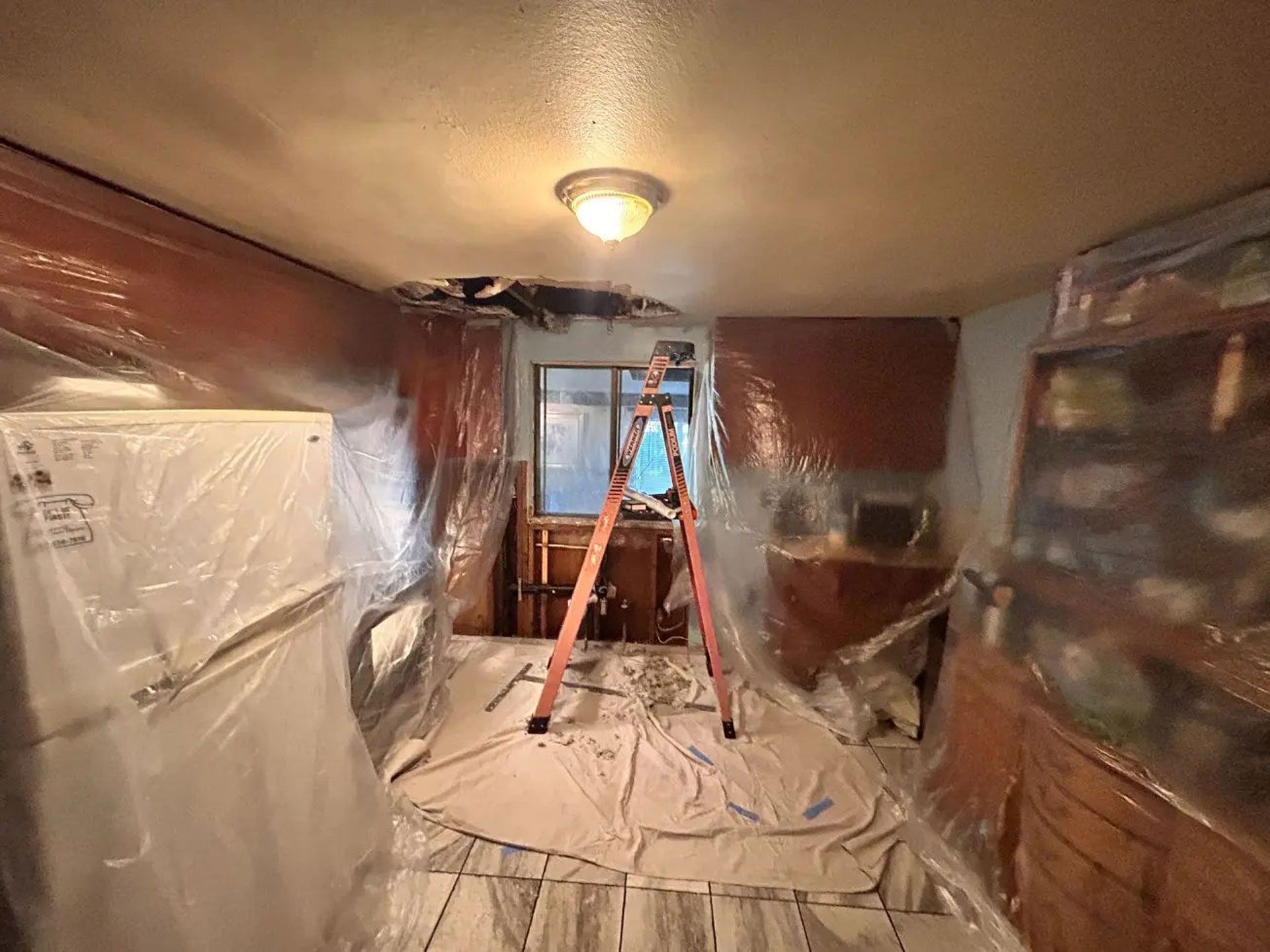 A kitchen covered in plastic