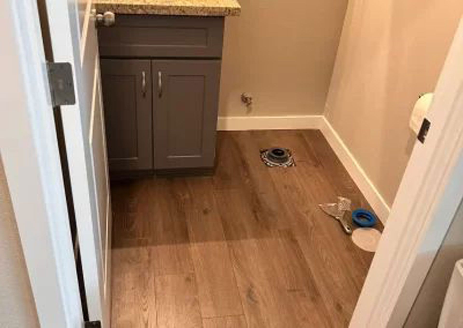 A bathroom with hardwood floors