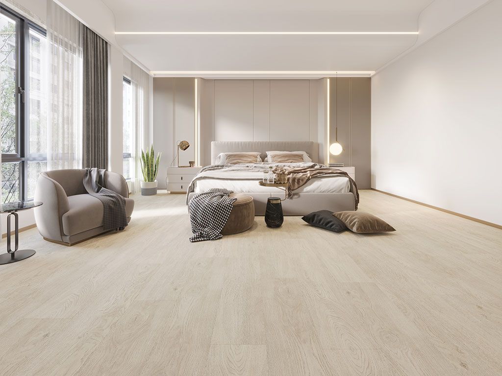 A bedroom with a bed , chair , table and window.