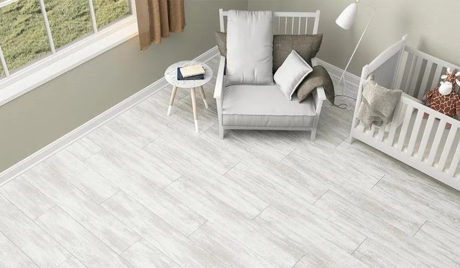 There is a chair and a crib in the room.