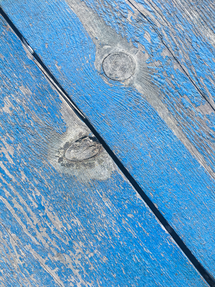 Close-up photo of a blistered blue paint.