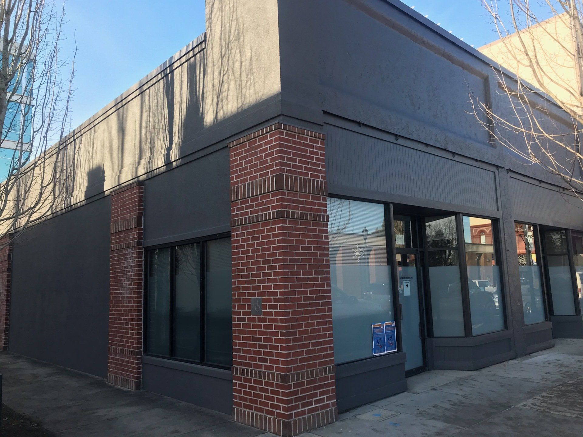 A newly constructed white commercial office building