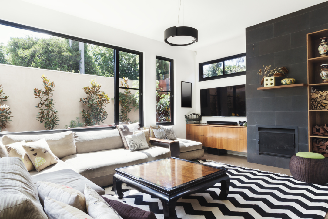 Monochrome living room with wood and grey tiling accents.