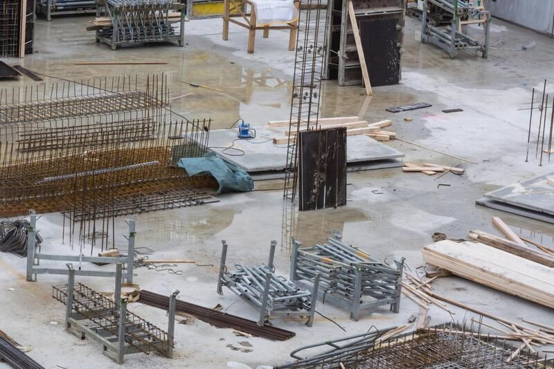 A construction site with a lot of concrete and metal.