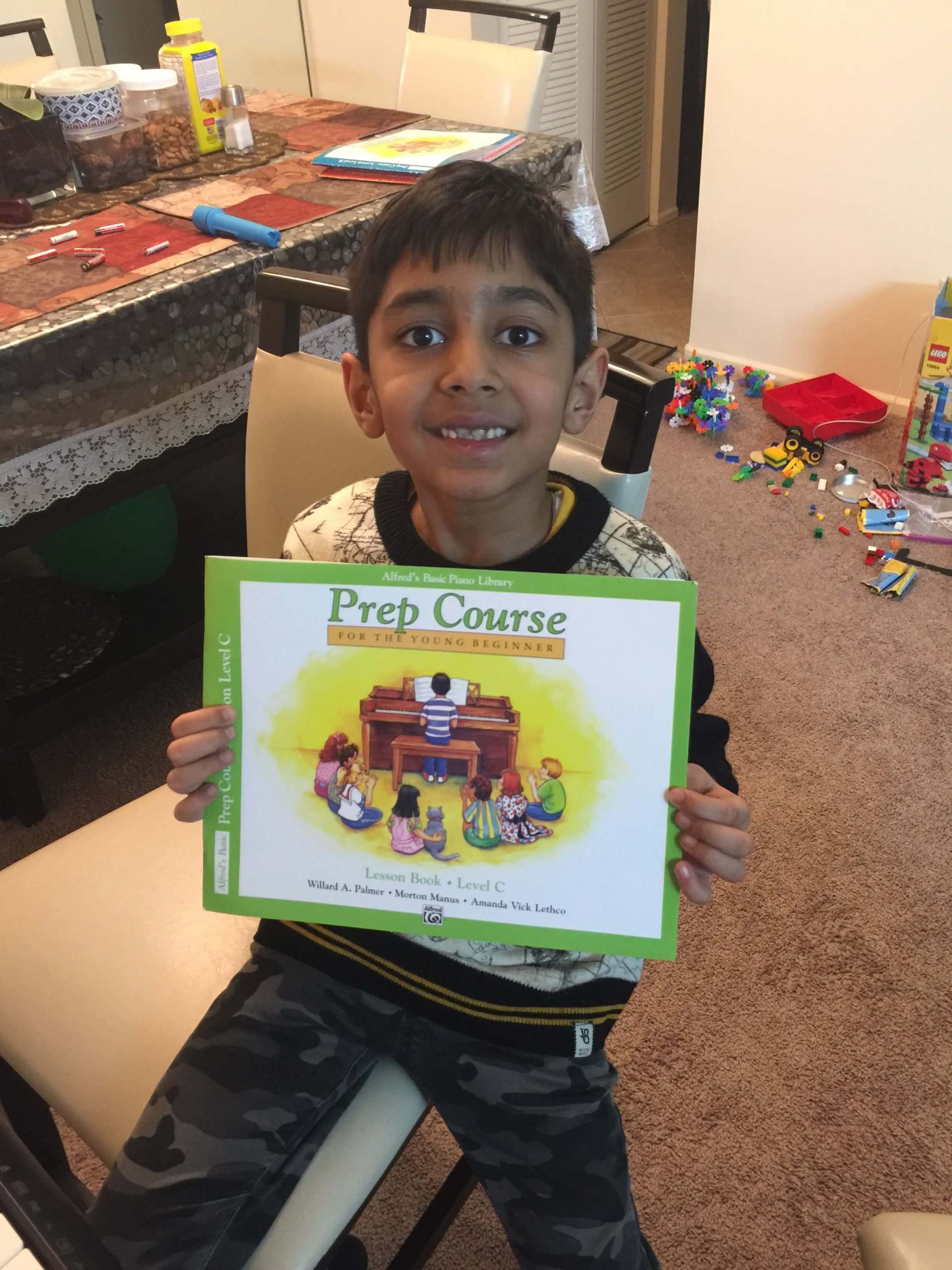 Kid Holding Prep Course Book — A Plus In Home Guitar Lessons — Arlighton Heights, IL