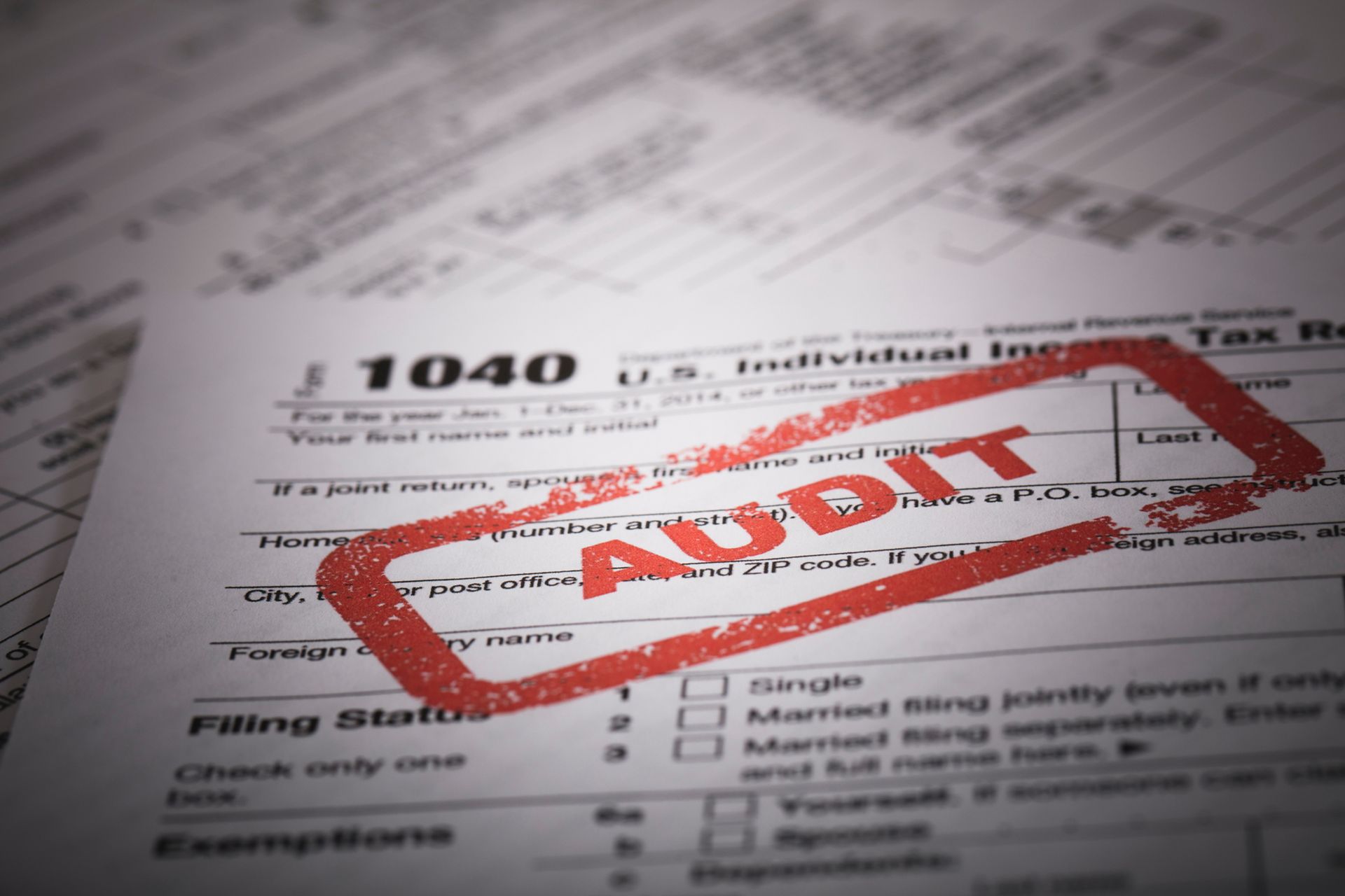 1040 tax form with a red audit stamp on it.