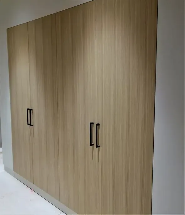 There is a desk with a computer on it in the room.