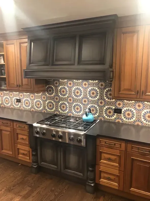 A kitchen with wooden cabinets , stainless steel appliances , and a stove top oven.