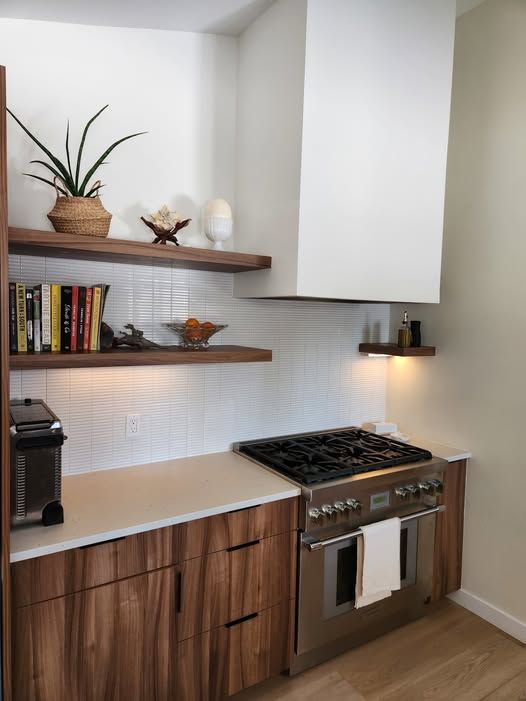 A kitchen with stainless steel appliances and wooden cabinets