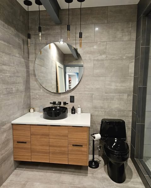 A bathroom with a sink , toilet and mirror