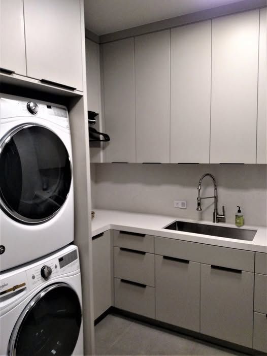 A laundry room with a washer and dryer stacked on top of each other.