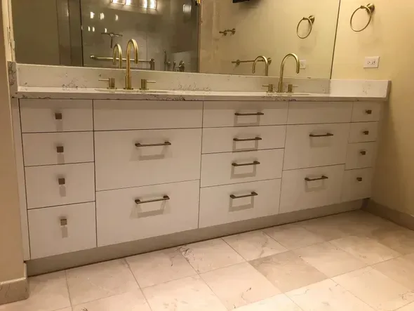 A bathroom with two sinks and a large mirror.