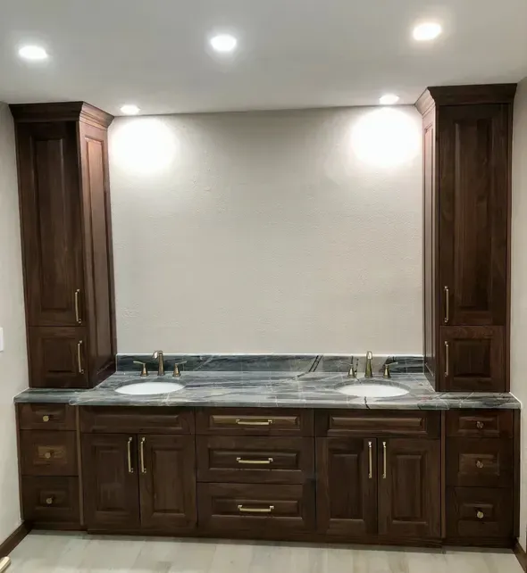 A bathroom with two sinks and wooden cabinets