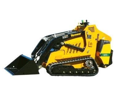 A bulldozer is carrying bales of hay on a trailer.