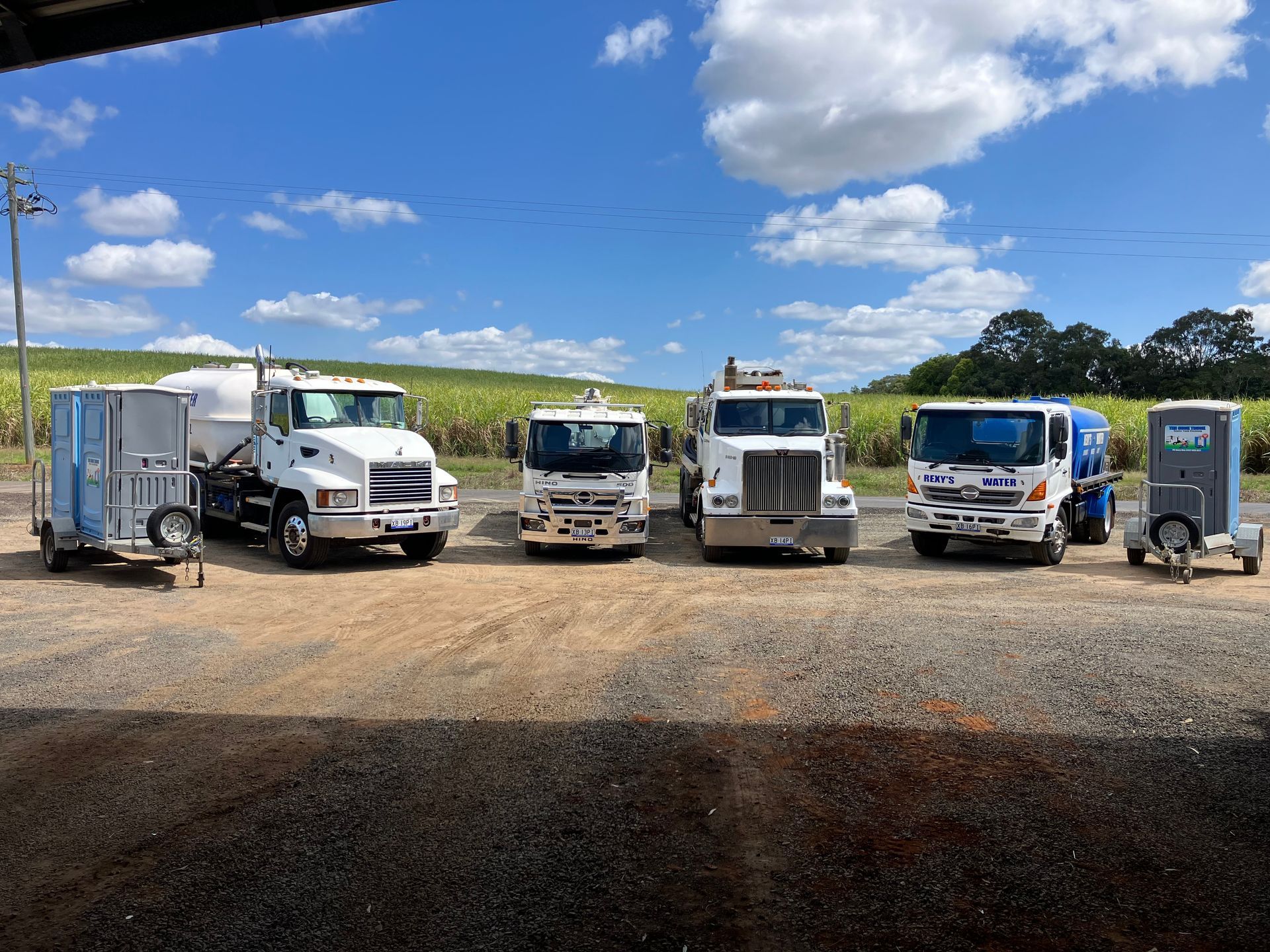 A vacuum truck is parked on the side of the road.