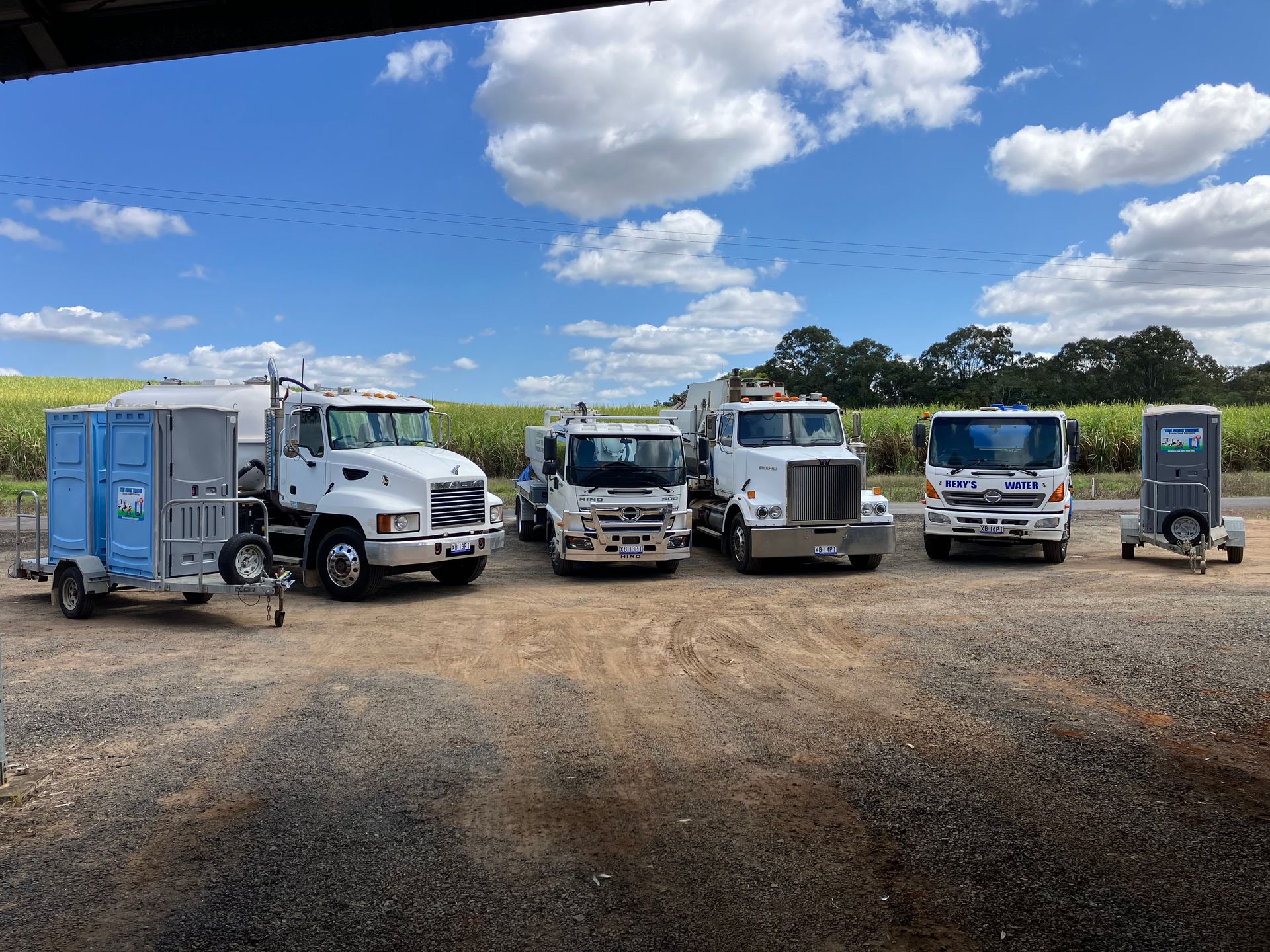 A water truck is parked on the side of the road