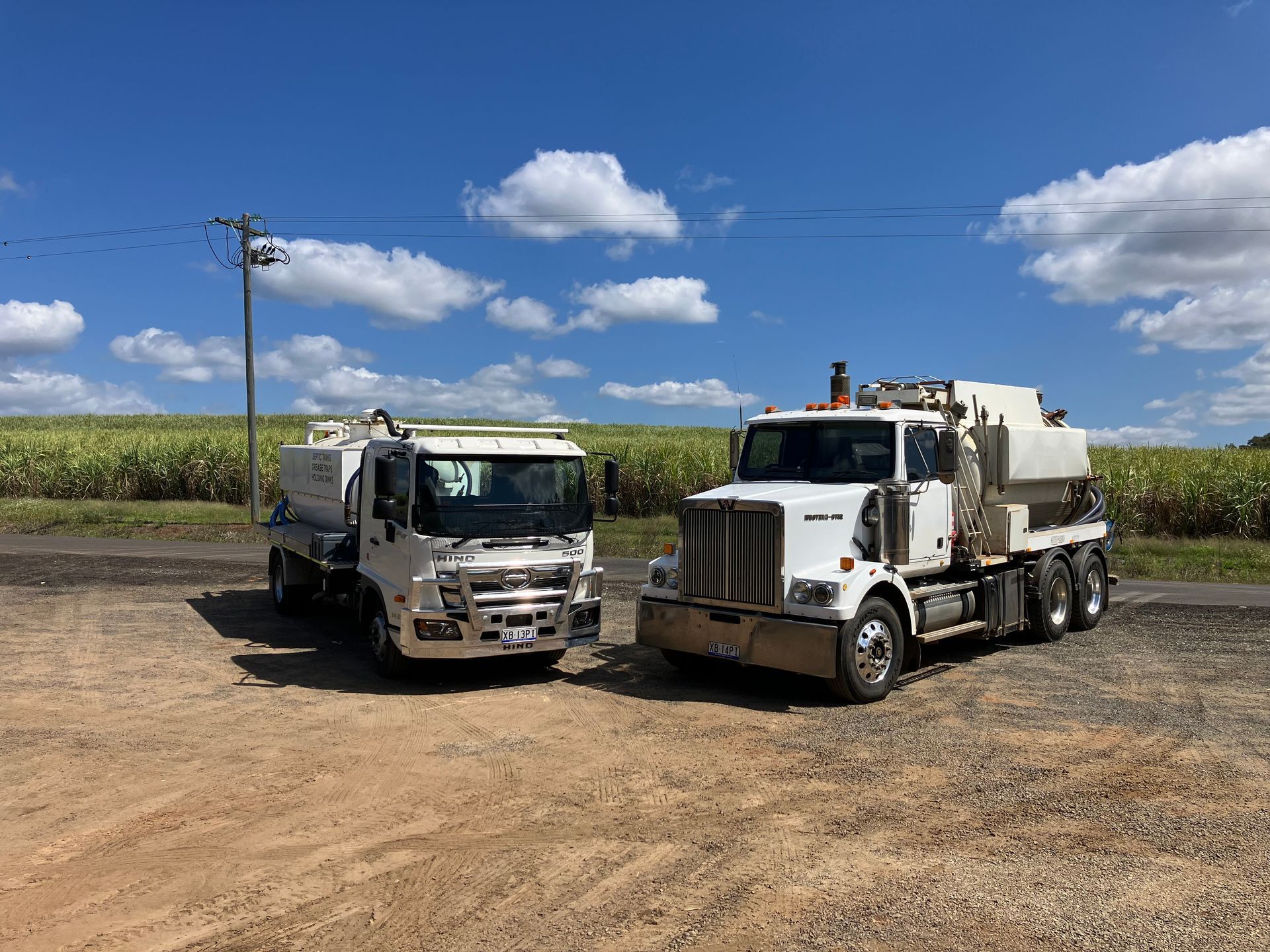 A dump truck is spraying water on the ground