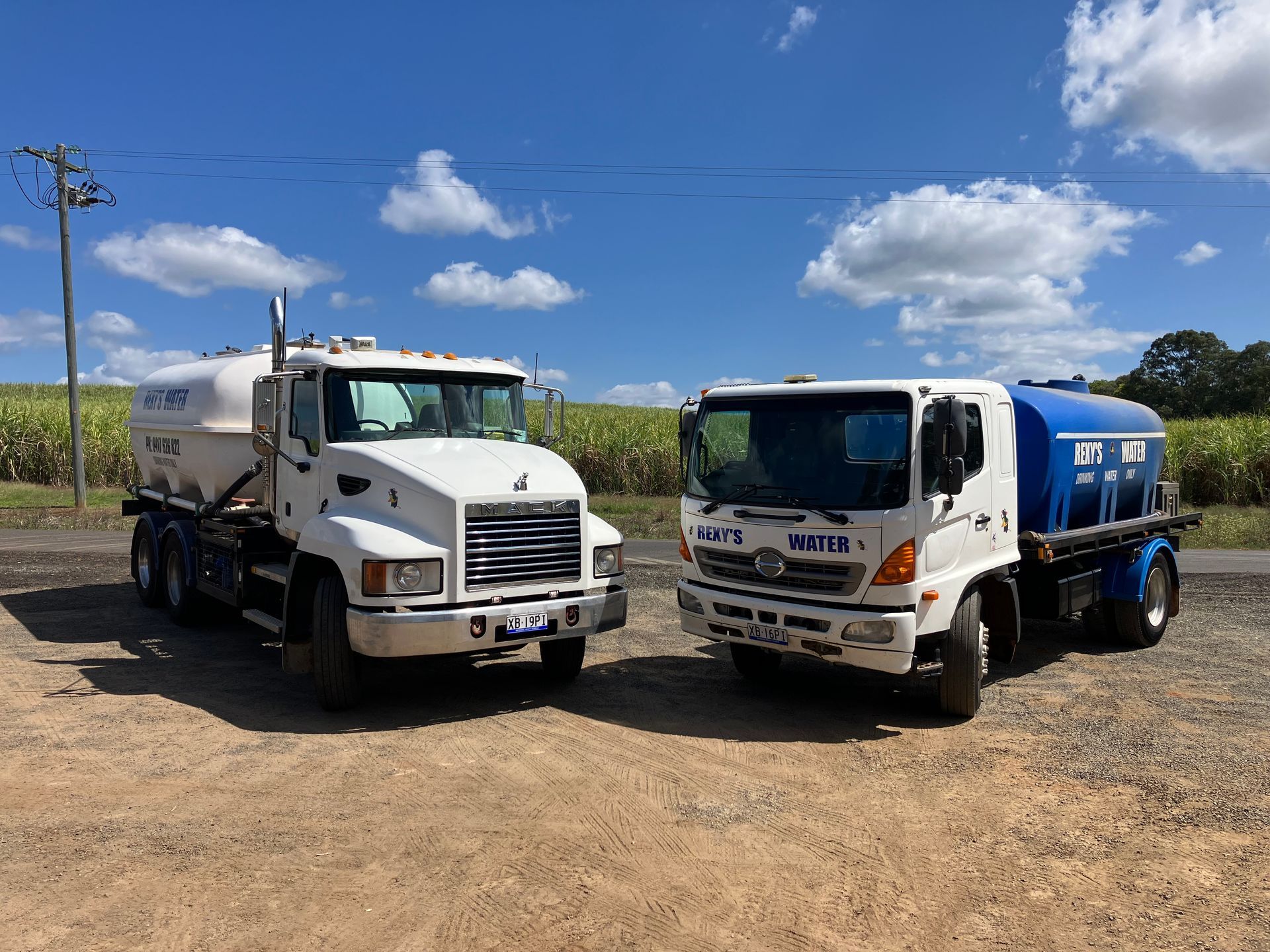 A white water truck is parked in a parking lot