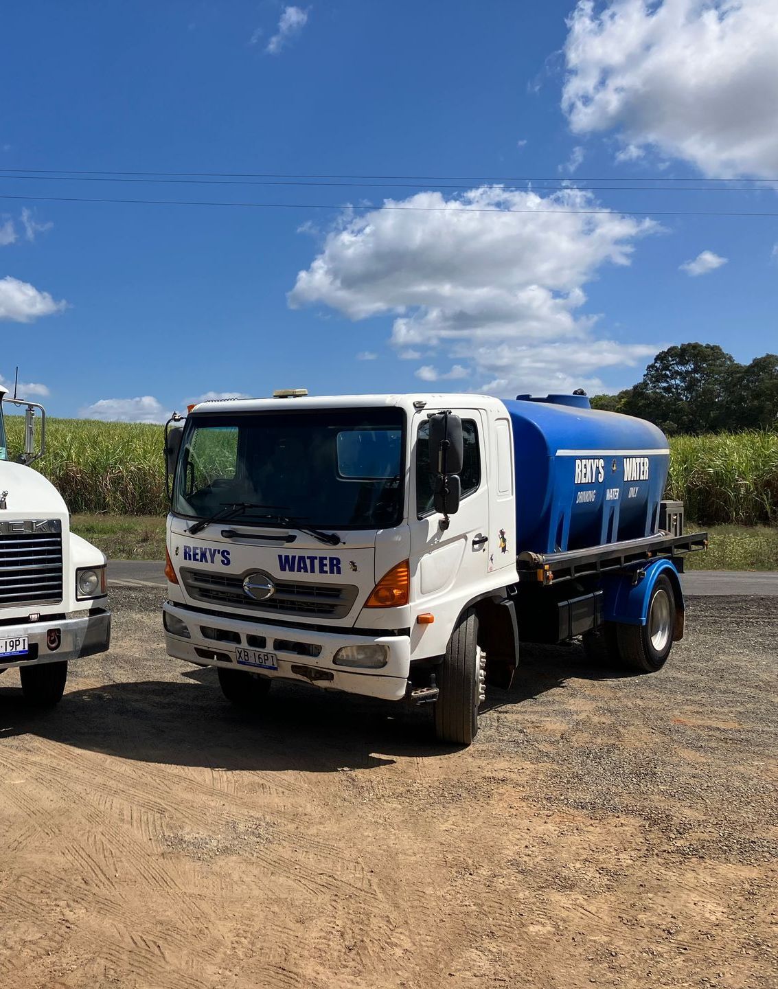 A h2o truck is parked on the side of the road