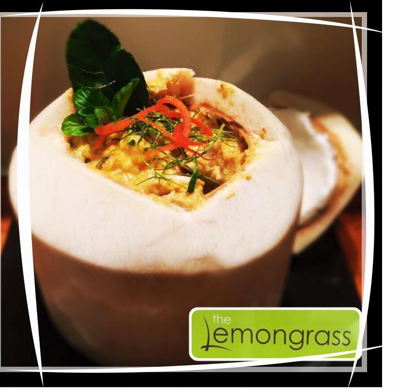 A picture of a coconut filled with food from the lemongrass restaurant