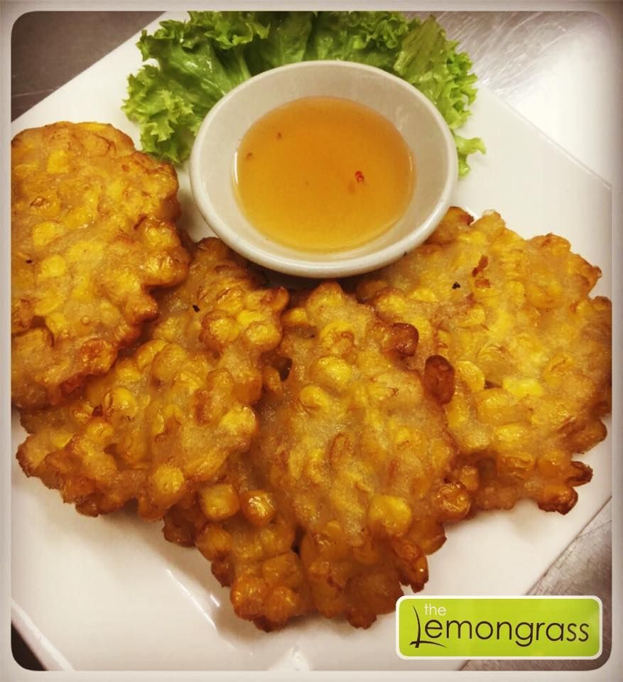 A plate of corn fritters with a dipping sauce from the lemongrass