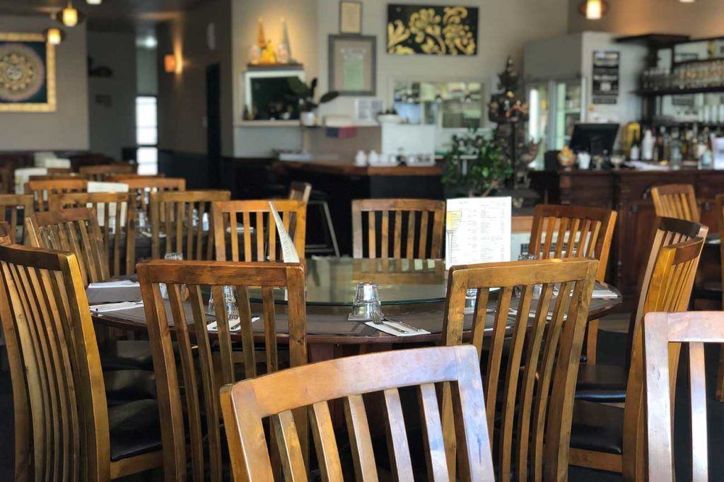 A restaurant filled with wooden tables and chairs.