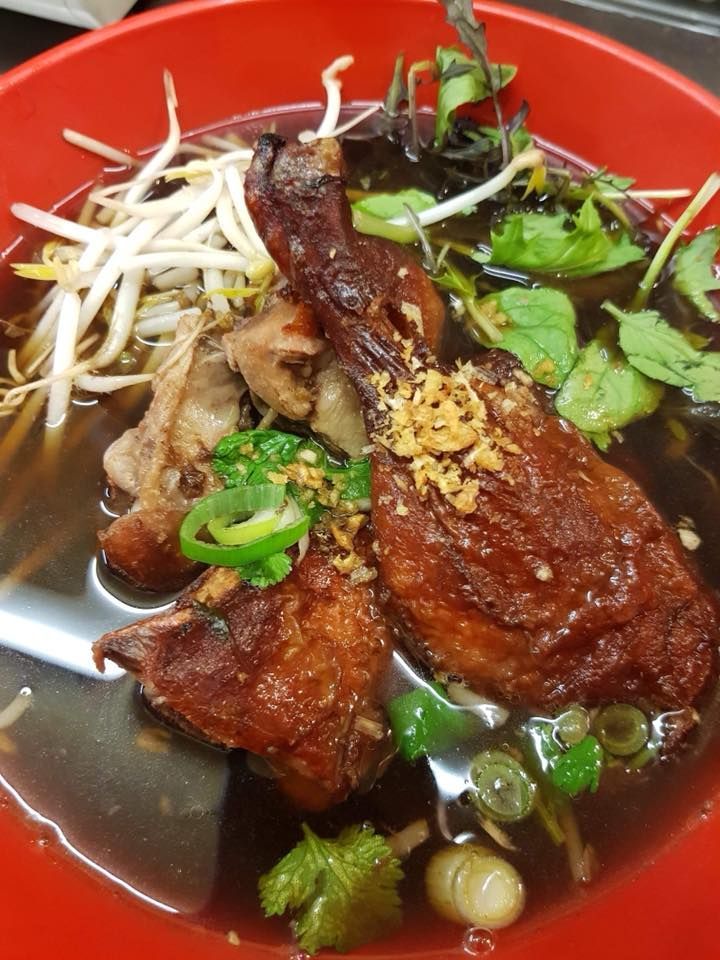 A close up of a bowl of soup with meat and vegetables