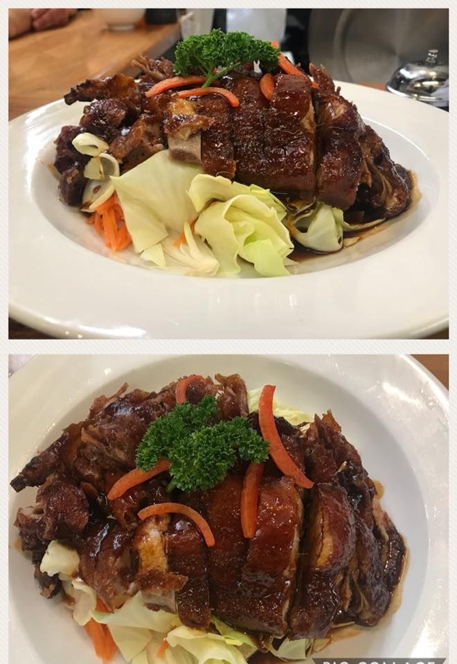 Two plates of food with meat and vegetables on a table.